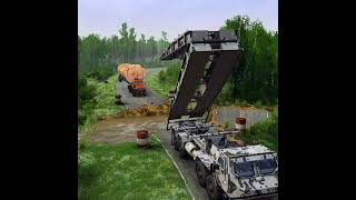 Military trucks lower the makeshift bridge