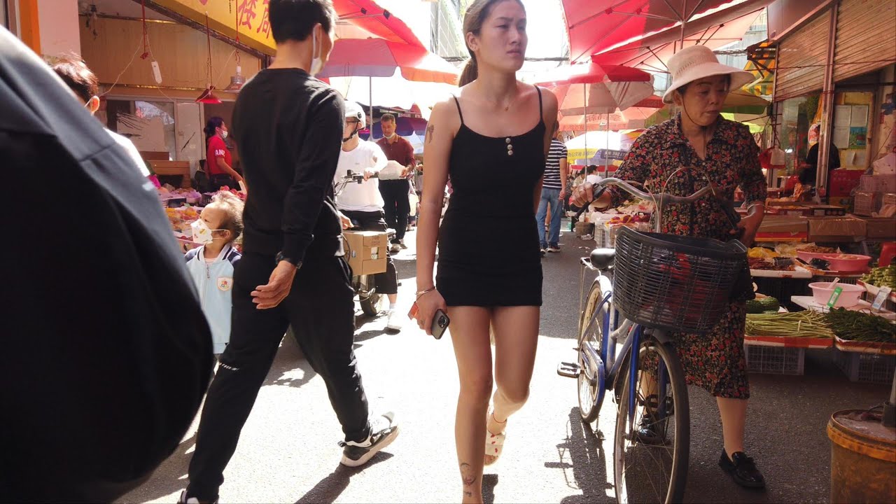 Оживленный овощной рынок в деревне Танся, многие женщины покупают овощи и морепродукты всех видов.