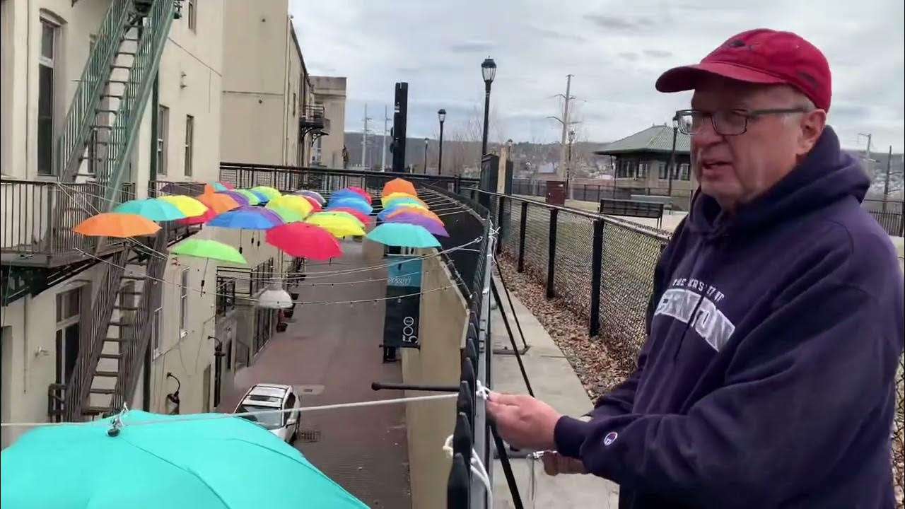 Swinging in the Rain, and Sun Umbrellas brighten quirky alley in