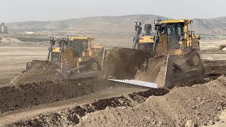 Caterpillar D9T And Komatsu D275 Bulldozers Team Levelling A Huge Old Mining Area
