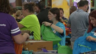 Thousands of volunteers filling backpacks for kids in need