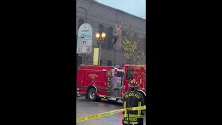 Man crosses wires in Vancouver, falls onto fire truck image