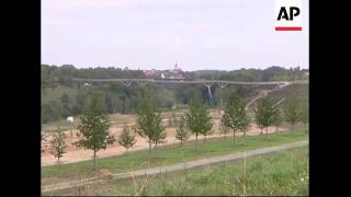 SHOTLIST 1. Zoom out of bridge 2. Side view of bridge over valley 3. Pan of bridge 4. Close up railing of wooden bridge 5.