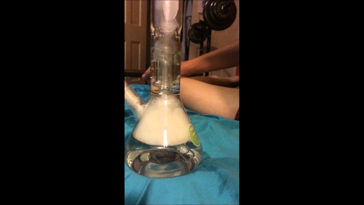 slow-mo bong rip focused on shower head perc.