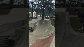 Skateboarder drops in on half pipe and lands on his face at skatepark