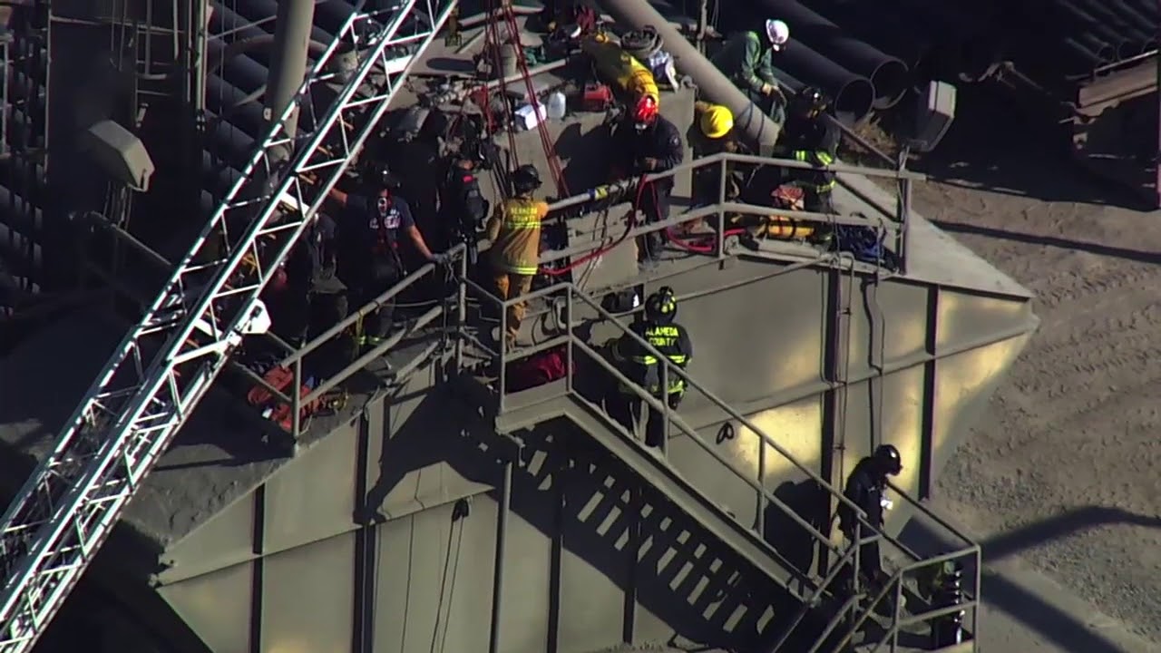 Crews work to rescue man stuck in cement mixer