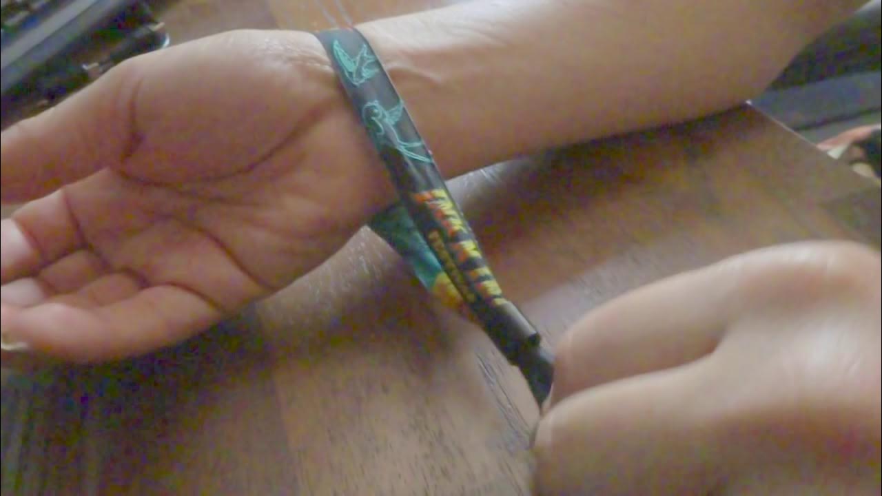 How to remove a fabric and plastic festival wristband - YouTube