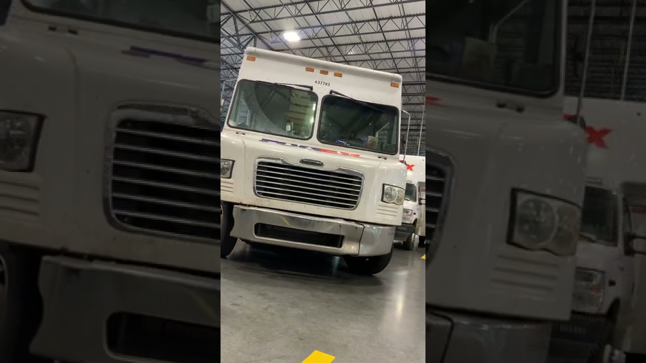 Parking a FedEx truck at the station between 2 trucks