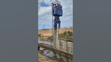 Driving concrete sheet pile along the canal