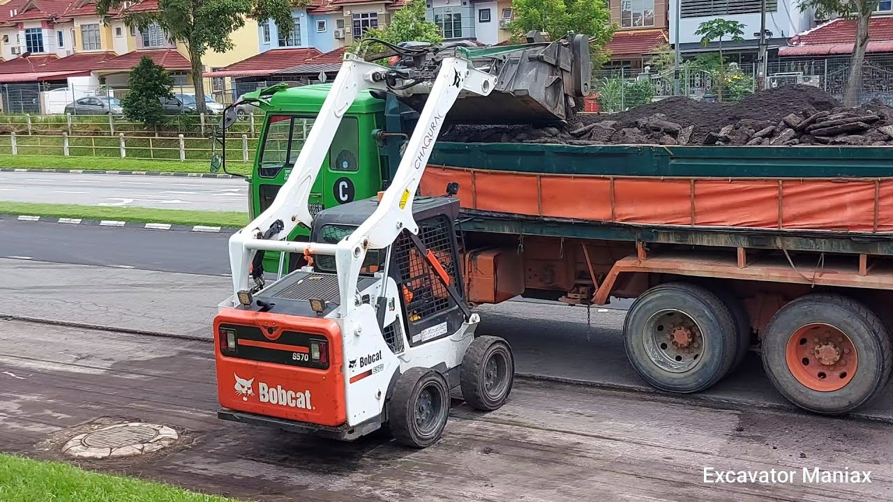 Bobcat S370 With Sweeper Broom Loading Debris To Dump Truck