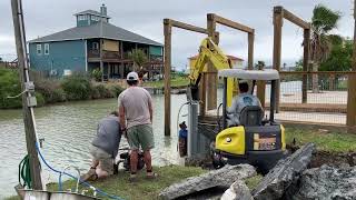 Installing the first new bulkhead sea wall panel at our Rockport house!