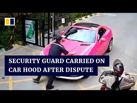 Security guard carried on hood of car after dispute in China