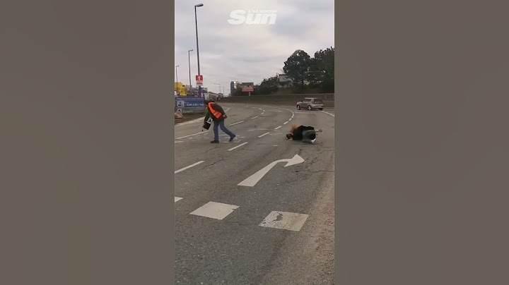 Hilarious moment Just Stop Oil protester slips in liquid she is pouring onto road