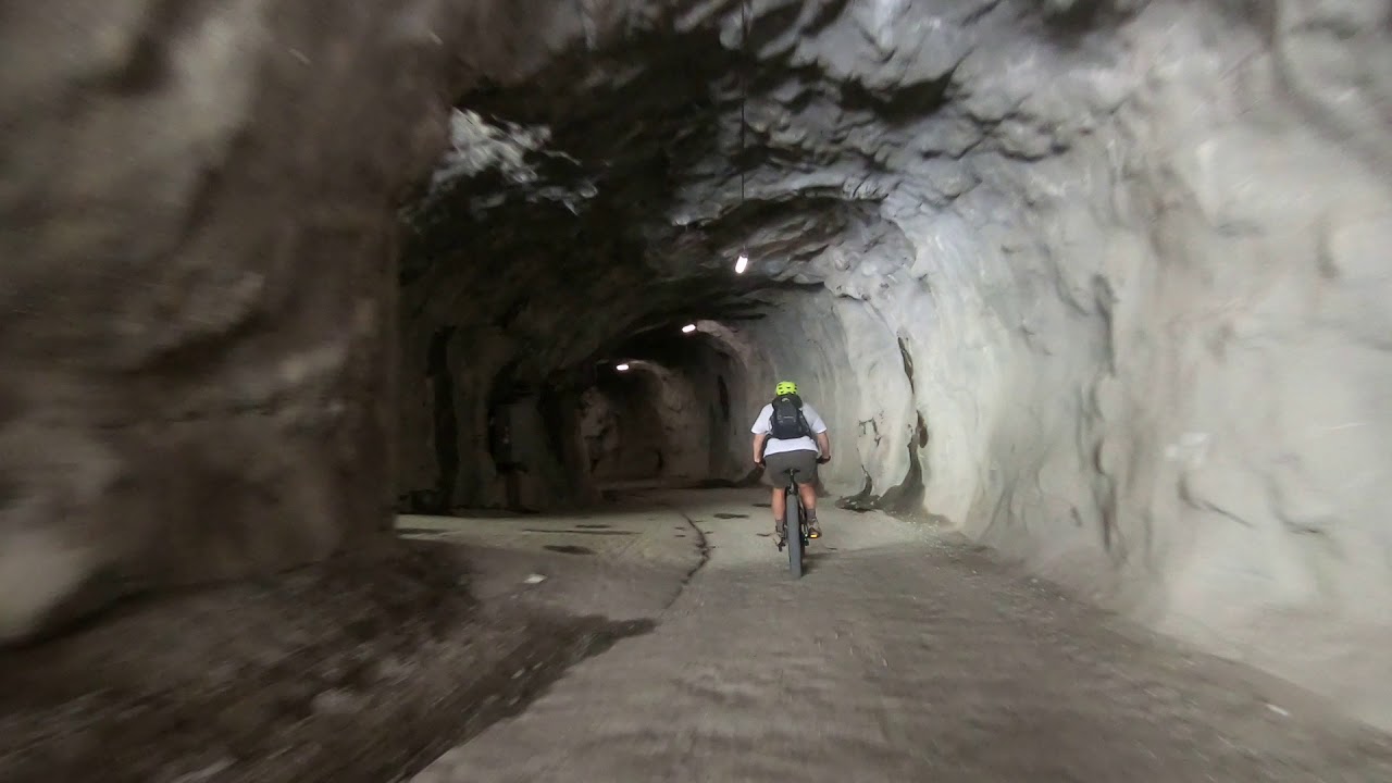 Biking through the spooky tunnel by the dam above Zmutt