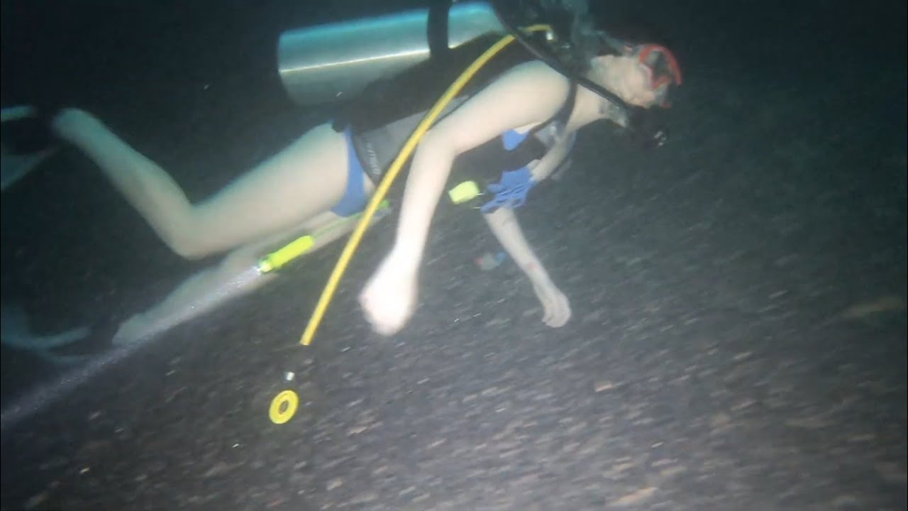 Group of Scuba Divers explore deep crater