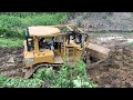 Large d6r bulldozer operator leveling muddy ground very powerful