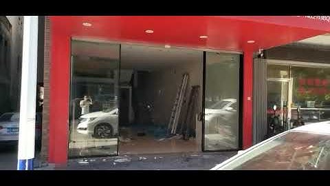 Linear magnetic drive automatic sliding door opener installed in a new shop.