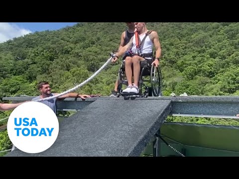 Man in wheelchair attached to bungee plunges nearly 165 feet off roof | USA TODAY