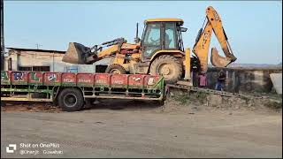 JCB Backhoe loader unloading from trailer