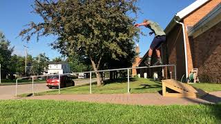 Inline skater jumps ramp to grind rail and lands on a sensitive area