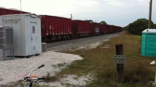 FEC TRAIN 336#587 w/ a swat team truck going over the track after the train