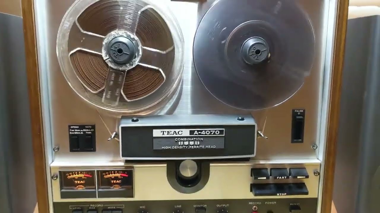 A Teac A-4070G reel to reel stereo tape deck, with original manual