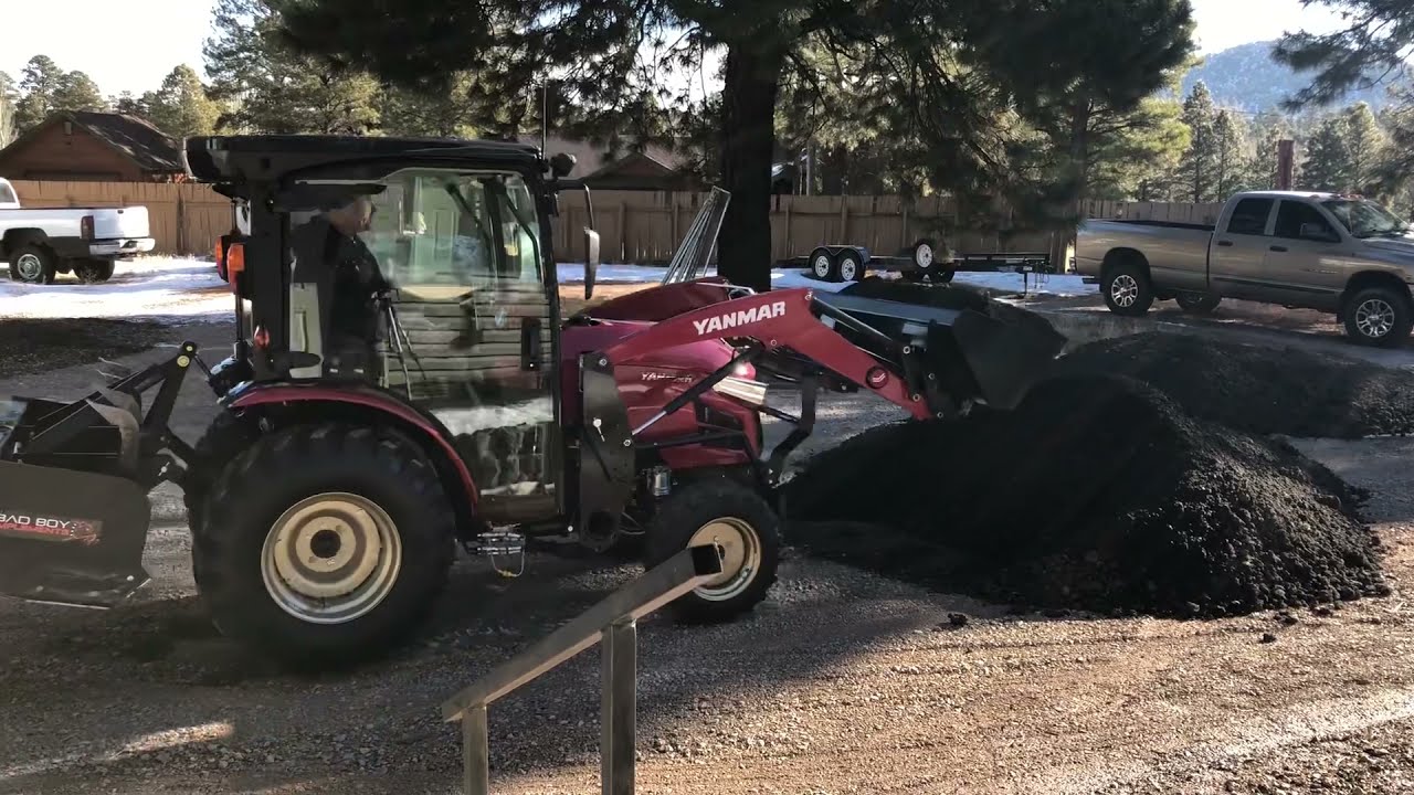 Yanmar YT235C grading asphalt millings.