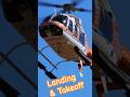 One Bell 407 Helicopter lands and the other takes off