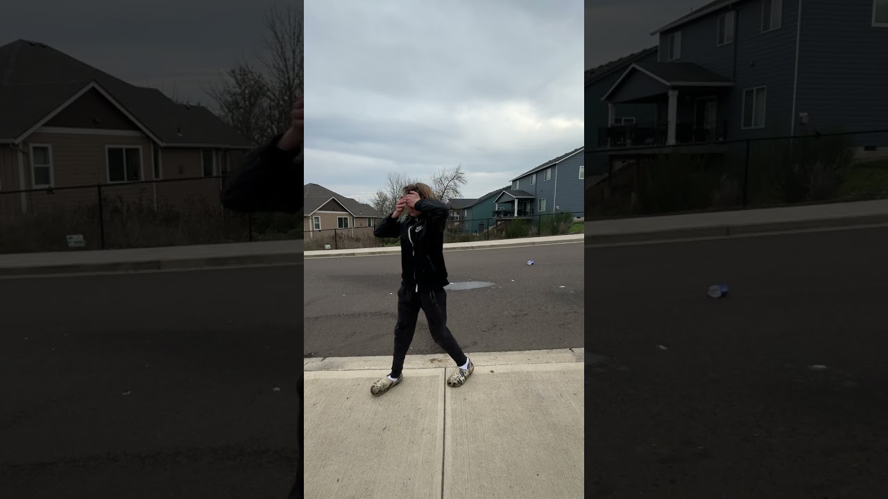 Boy puts baking soda in bottle and shakes it then throws it on floor in street and hits his face