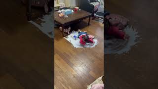 Precious Child Explores Spilled Milk