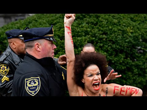 Bill Cosby confronted by topless protester