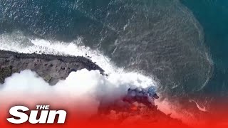 La Palma towns locked down as lava streams into ocean