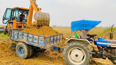 JCB 3dx Backhoe Loader Machine Loading Mud In Mahindra Yuvo and Powertrac John Deere Tractor