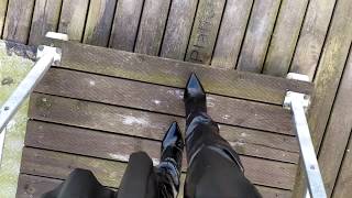 LadyIVE in shiny thigh high boots walks on the bridge