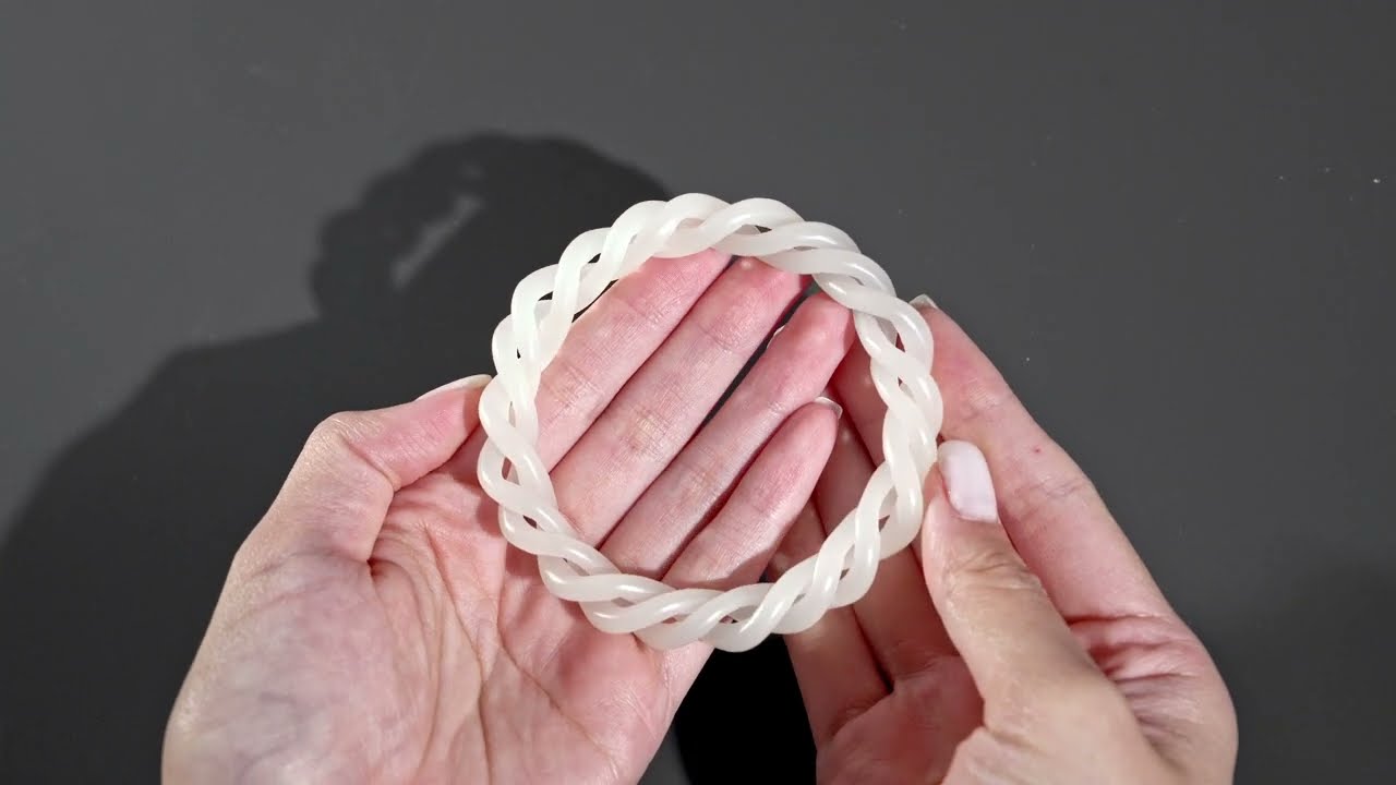 Lot 465 - A WHITE JADE ROPE-TWIST BANGLE, QING DYNASTY
