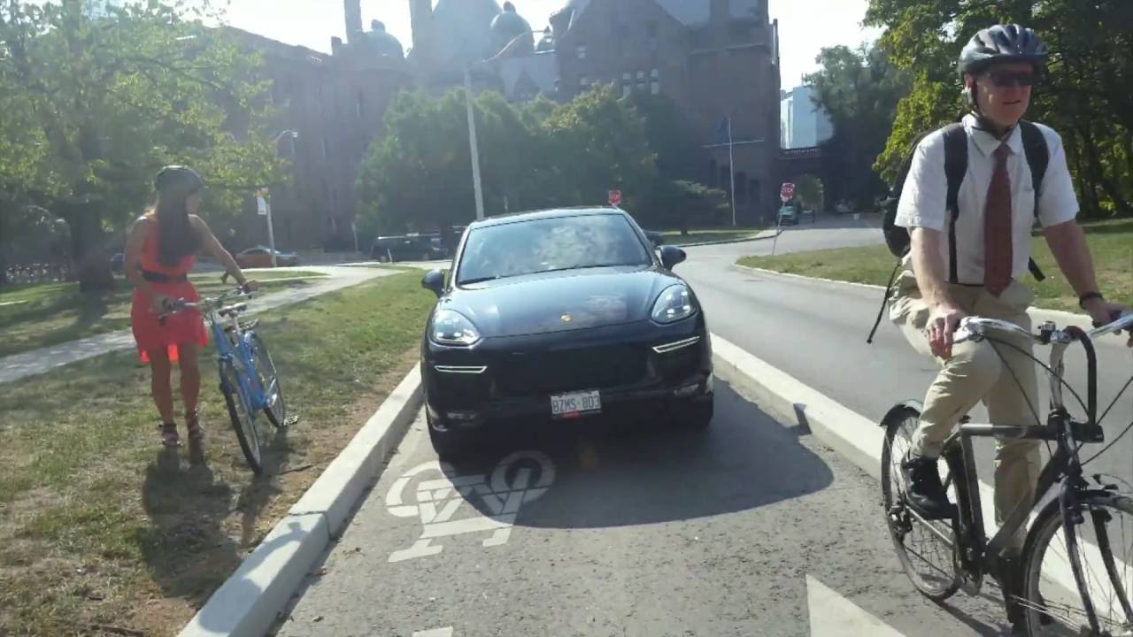 Toronto cyclists compete with vehicles on dedicated bike lanes