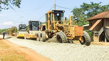 Processing Mixing Gravel Using A Dresser Motor Grader Spreading To Build A Village Foundation Road