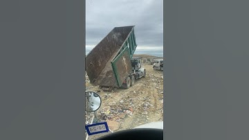 Roll-Off Garbage Truck Unloading at Landfill