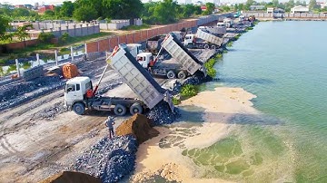 Perfect Activities Group 18ton Dump Trucks Unloading Stones Increasing Long Road Over The Water