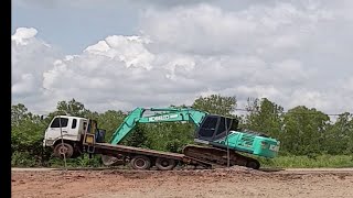 HUGE BACKHOE LOADING ON SMALL FLATBED TRUCK IN THAILAND