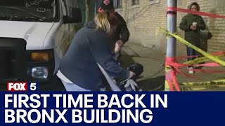 Residents take some belongings from Bronx building