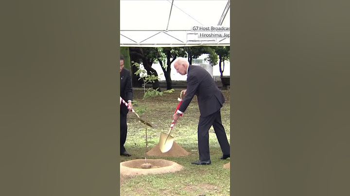 Joe Biden and Emmanuel Macron plant a tree