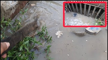 Removal Plastic and Trash Clogged Culvert Drain on Street After Heavy Rain