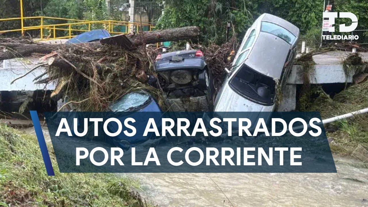 Vehicles end up in a stream after being swept away by the current during rains in Santiago, NL.