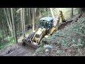 New Holland LB 115.B backhoe digging forest road II.