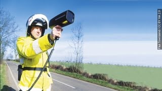 Police Fine Man Holding Sign Warning Drivers Of Speed Trap