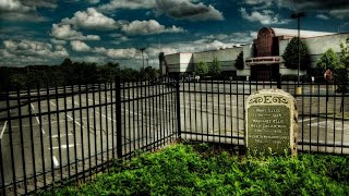 Why is there a graveyard at a movie theatre parking lot?