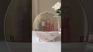 Organize your beauty essentials in style with this oval-shaped vanity storage case.