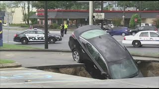 Massive sinkhole opens up in the middle of a Florida parking lot