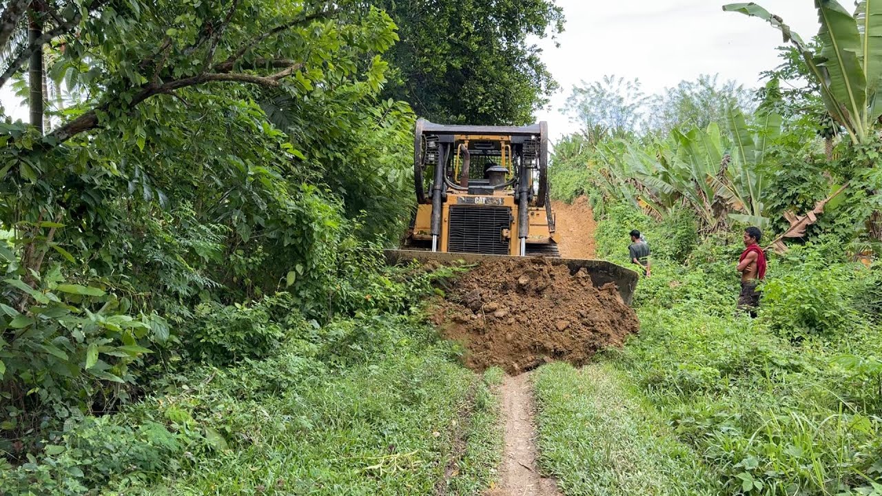 The process of road construction with full-power CAT D6R XL bulldozer